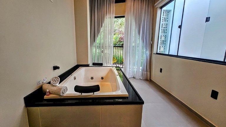 Two-story house with a whirlpool tub and barbecue area near